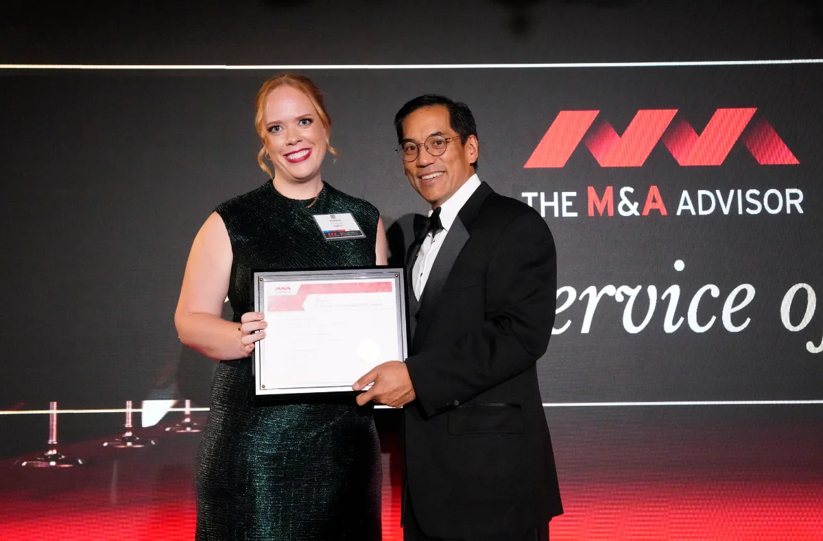 RingStone representative accepting the Due Diligence Firm of the Year award from The M&A Advisor